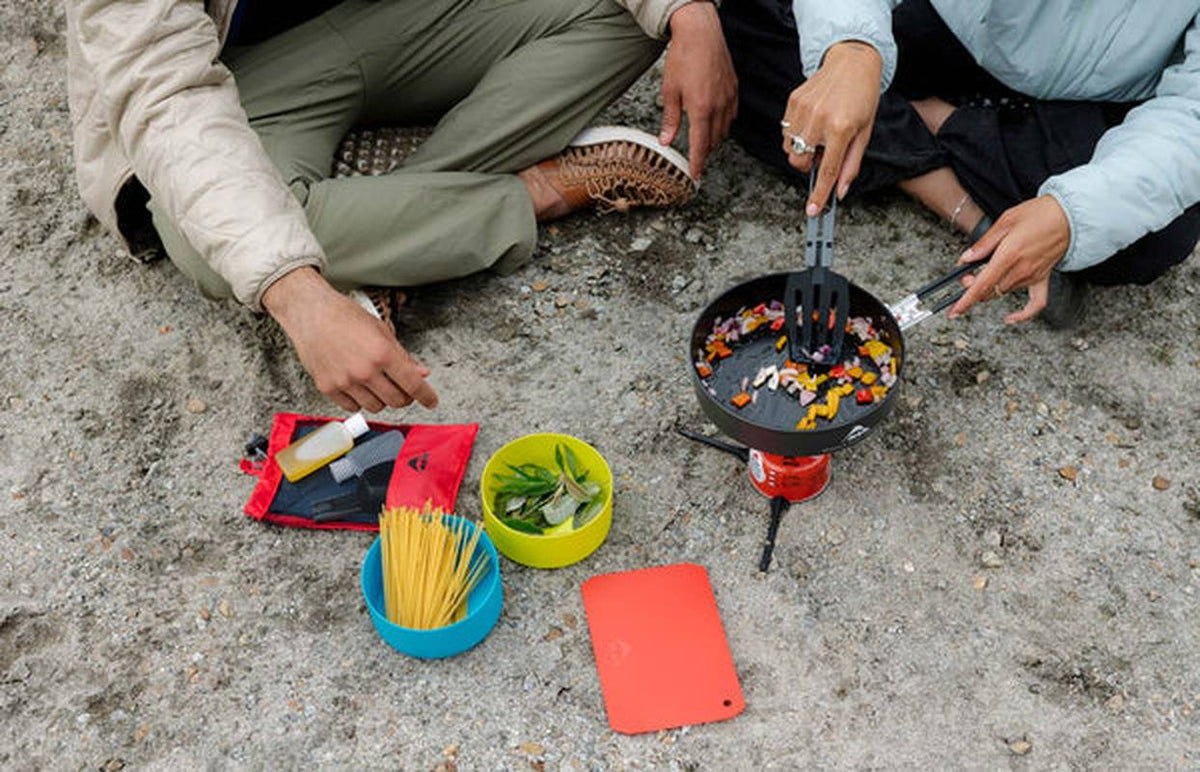 Köksset i användning utomhus med stekpanna och grönsaker