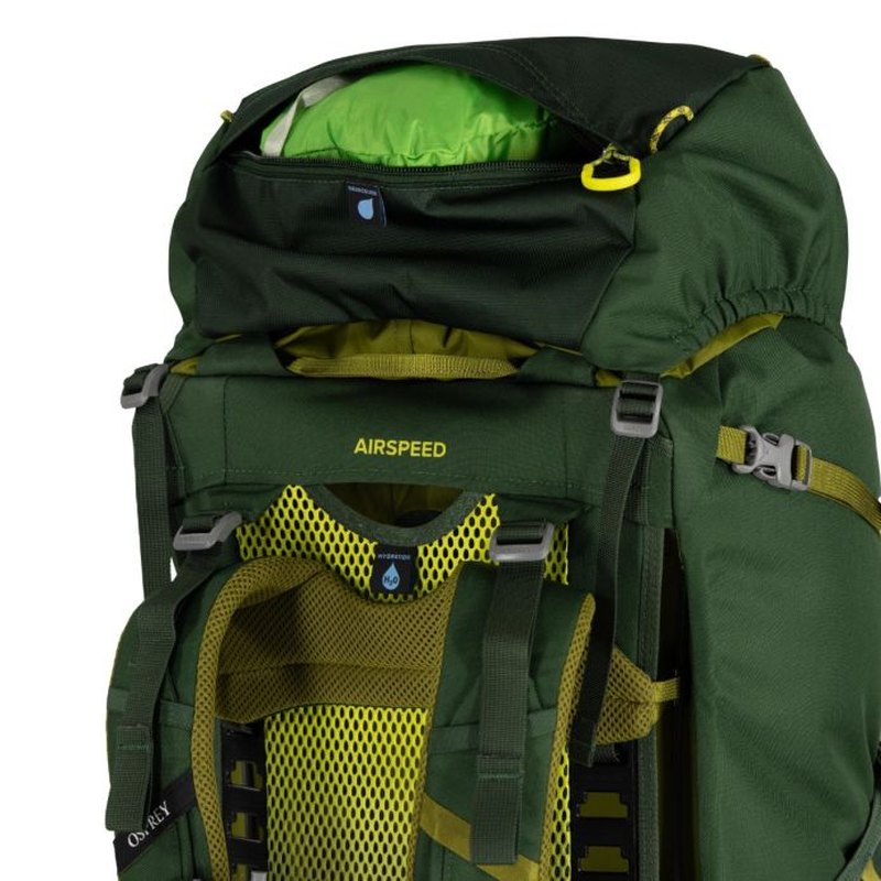 Öppnat lockfack på mörkgrön Osprey Ace 50 med limegrön insida